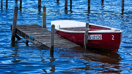 jon boat beside beach dock thumbnail