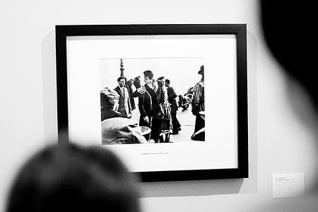 grayscale photo of man near statue thumbnail