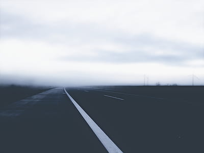 empty black asphalt road under white clouds during daytime thumbnail