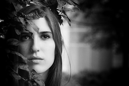 grayscale photo of woman on leaves thumbnail