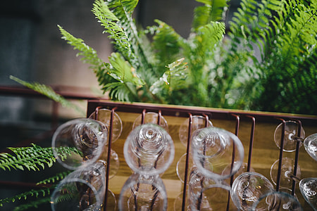 A big bunch of wine glasses hanging from a holder thumbnail