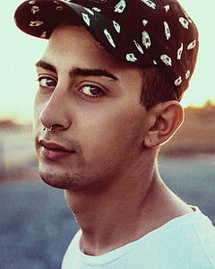 man wearing black cap and white shirt thumbnail