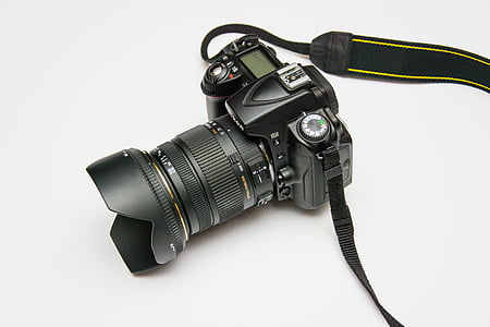 black DSLR camera on white surface thumbnail