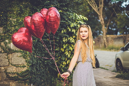 woman holding five heart red balloons thumbnail