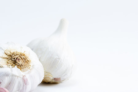 two garlic bulbs on white surface thumbnail
