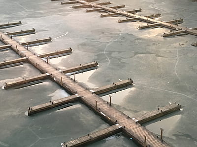 brown wooden dock in between ice cover body of water thumbnail