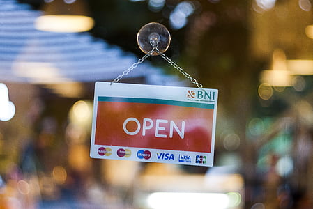 selective focus photographed of open hanging signboard thumbnail