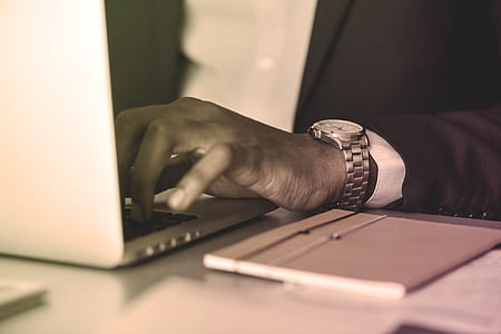 man using laptop computer on table thumbnail
