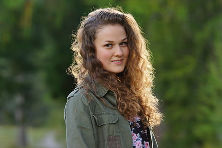 woman wearing green collared jacket outdoors thumbnail