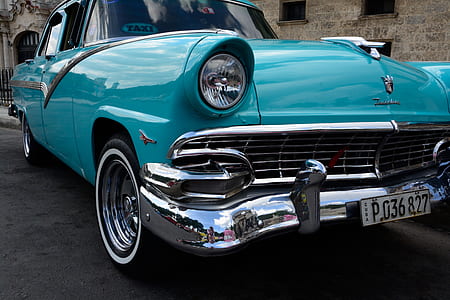 classic blue car parked near concrete building thumbnail