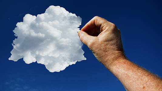 low angle photo of pointing right human arm towards white cloud on blue sky during daytime thumbnail