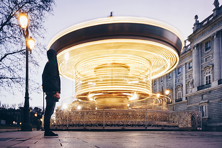 landscape photography of carousel near white building thumbnail
