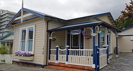 brown and blue wooden house under blue sky and white clouds during daytime thumbnail