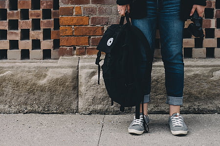 person holding black Converse knapsack thumbnail