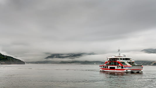 selective color photo of white ship on calm water thumbnail