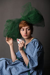 woman holding white and red floral tea cup thumbnail