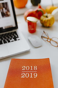 Female desk with orange notebook and pumpkins thumbnail