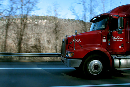 red semi-truck running on road during daytime\ thumbnail