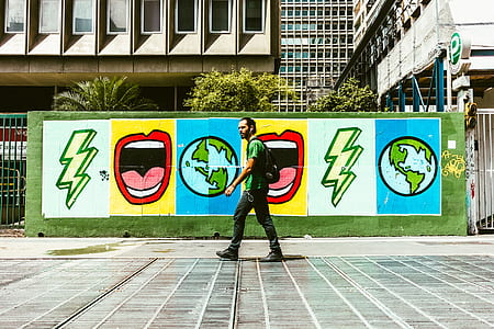 man walking in front of graffiti thumbnail