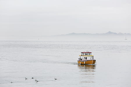 yacht in the sea under cloudy sky during daytime thumbnail