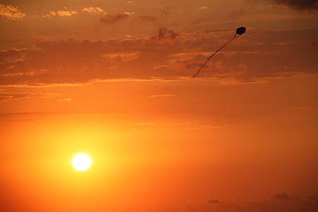 flying kite during golden hour thumbnail