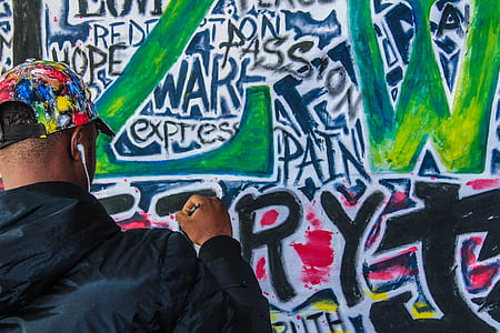 person painting graffiti on wall thumbnail