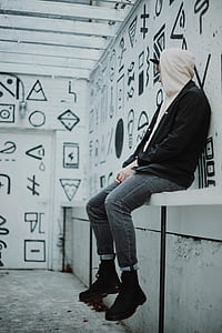 man sitting near wall thumbnail