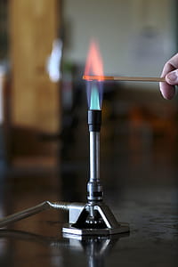 Calcium solution burning on a wooden splint in a bunsen burner flame. thumbnail