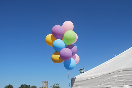 assorted-color balloon beside white tent during daytime thumbnail