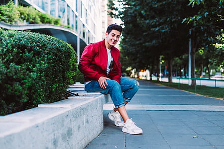 man sitting on concrete bench outdoors thumbnail