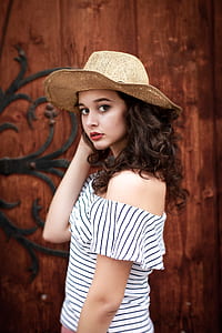 brown haired woman in off shoulder dress wearing brown ahrt thumbnail