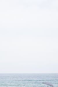 body of water under white cloudy sky during daytime thumbnail
