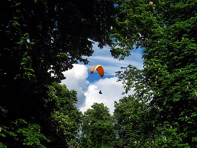 low angle view photo of person using parchute thumbnail