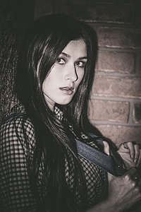 woman wearing gray and black blouse taking photo in dim lighted area thumbnail