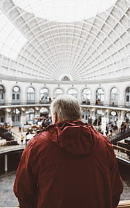 man in red jacket looking down at the house thumbnail