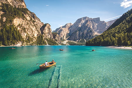 two people riding canoe on body of water during daytime thumbnail