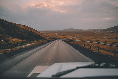 vehicle on gray concrete road during sunset thumbnail