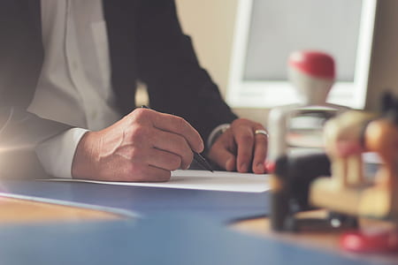 man writing on white printer paper thumbnail