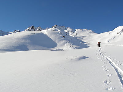 man standing on snow field under blue sky at daytime thumbnail
