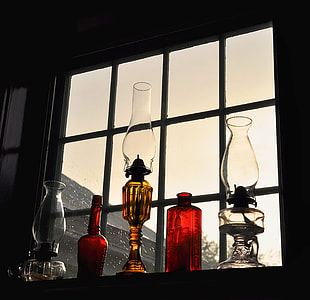 five oil lamps beside window thumbnail