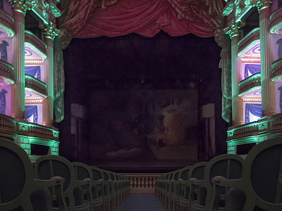 line of chairs in front of stage inside building thumbnail