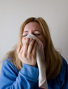 woman covering nose a white handkerchief thumbnail