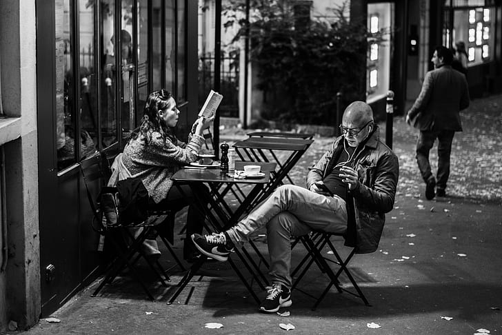 man and woman on cafe
