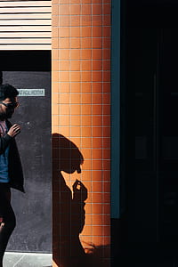 person standing near brown wall thumbnail