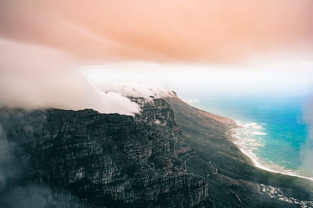 mountain range near body of water thumbnail