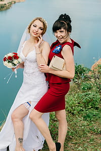 Woman in White Wedding Gown Holding Flowers Bouquet thumbnail