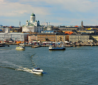watercrafts on body of water beside city during daytime thumbnail