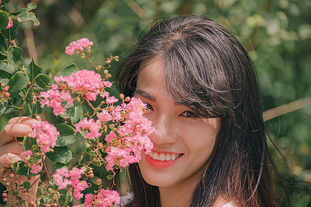 Photography of Smiling Woman Near Flowers thumbnail