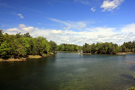calm body of water under cumulus clouds thumbnail
