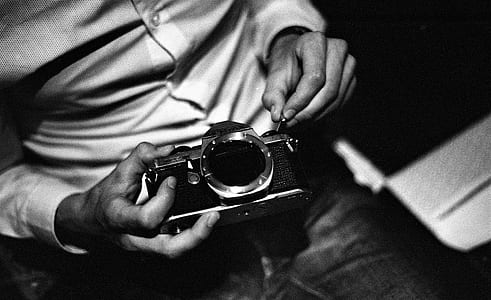 man holding camera thumbnail